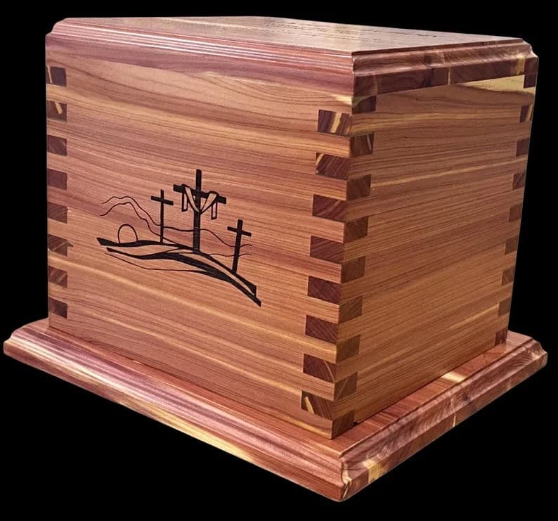 Aromatic cedar cremation urn with decorative cross inlays on the sides