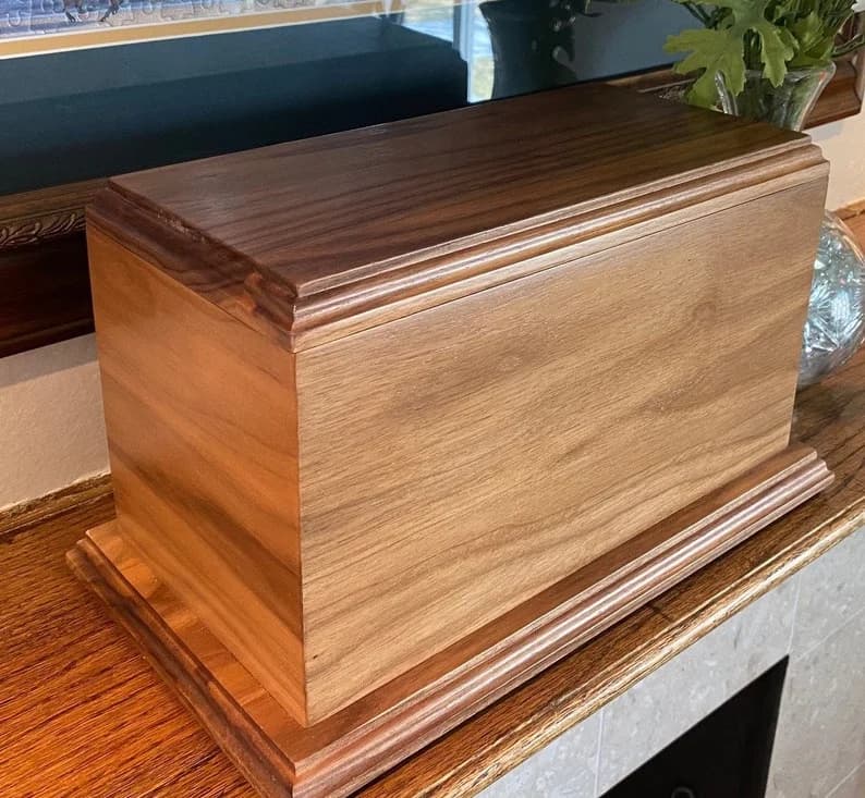 Handcrafted black walnut cremation urn with rich dark tones